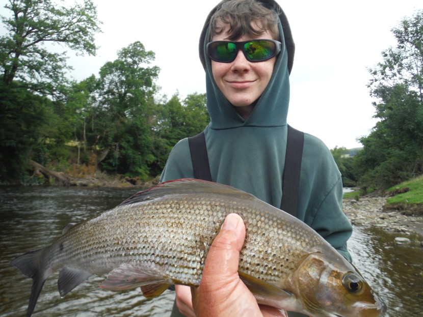 13 year old Jochem Schouten with his first grayling taken on a Deer Hair Emerger